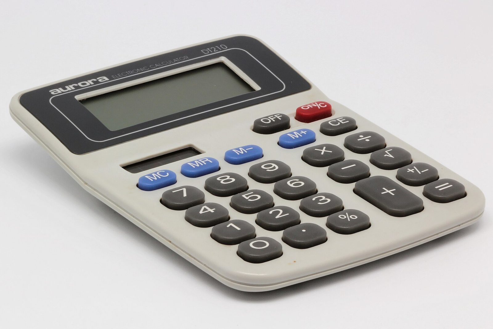 A gray desktop calculator with blue and red keys