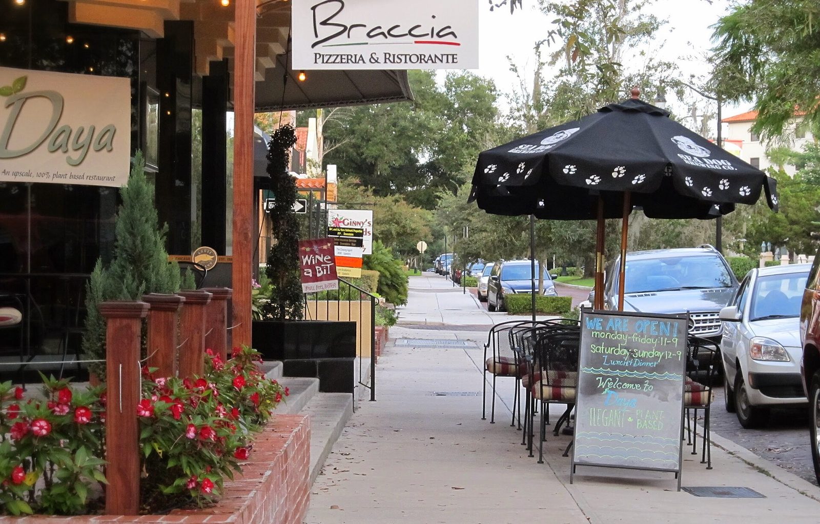 A restaurant patio with planters and sidewalk tables on Park Avenue in Winter Park, Florida