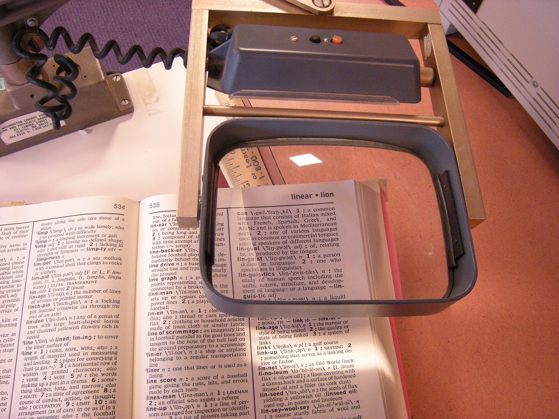 A large magnifying glass held over text