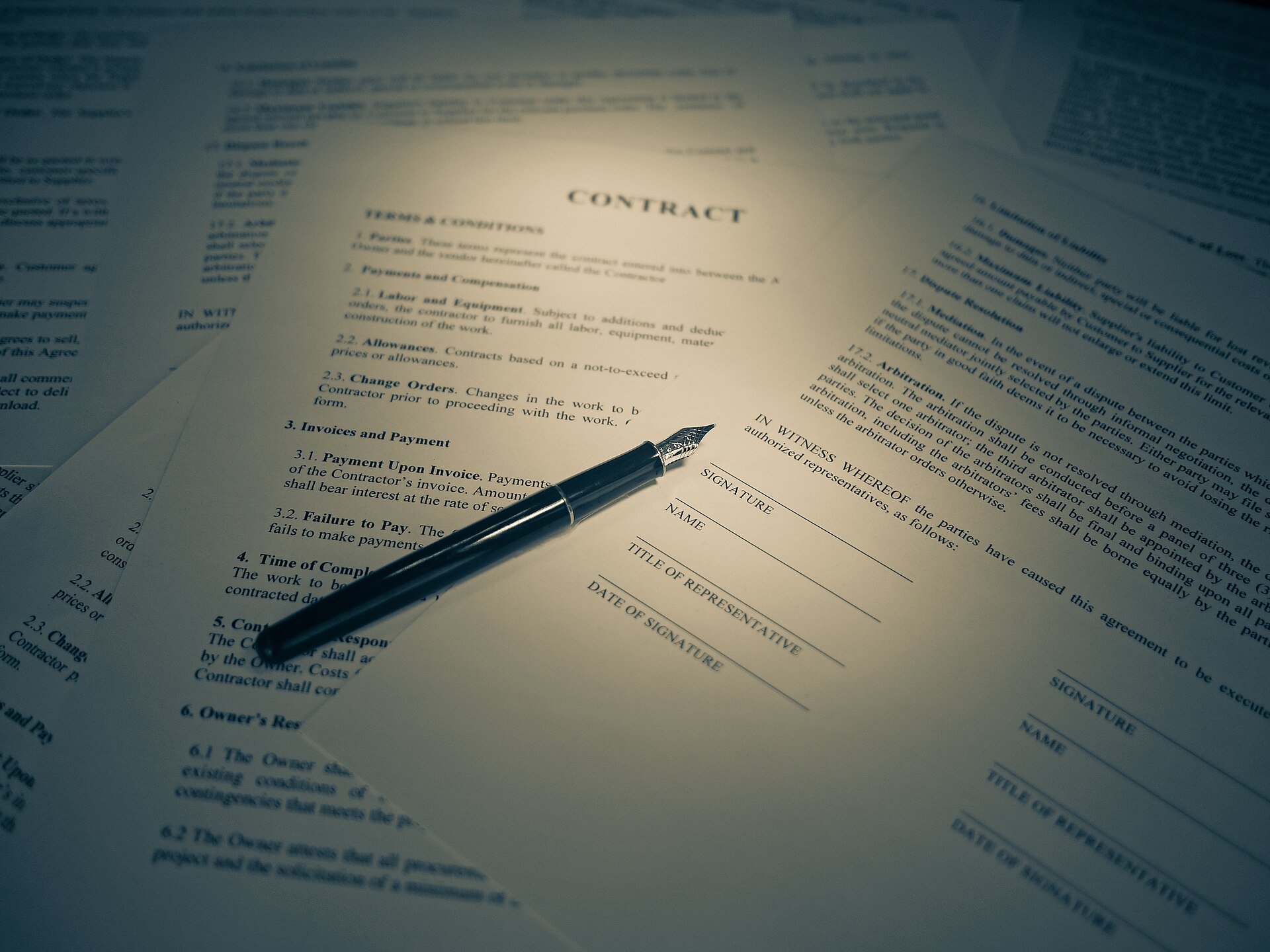 A close-up of a legal contract with a signature line — the moment most owners feel locked in.