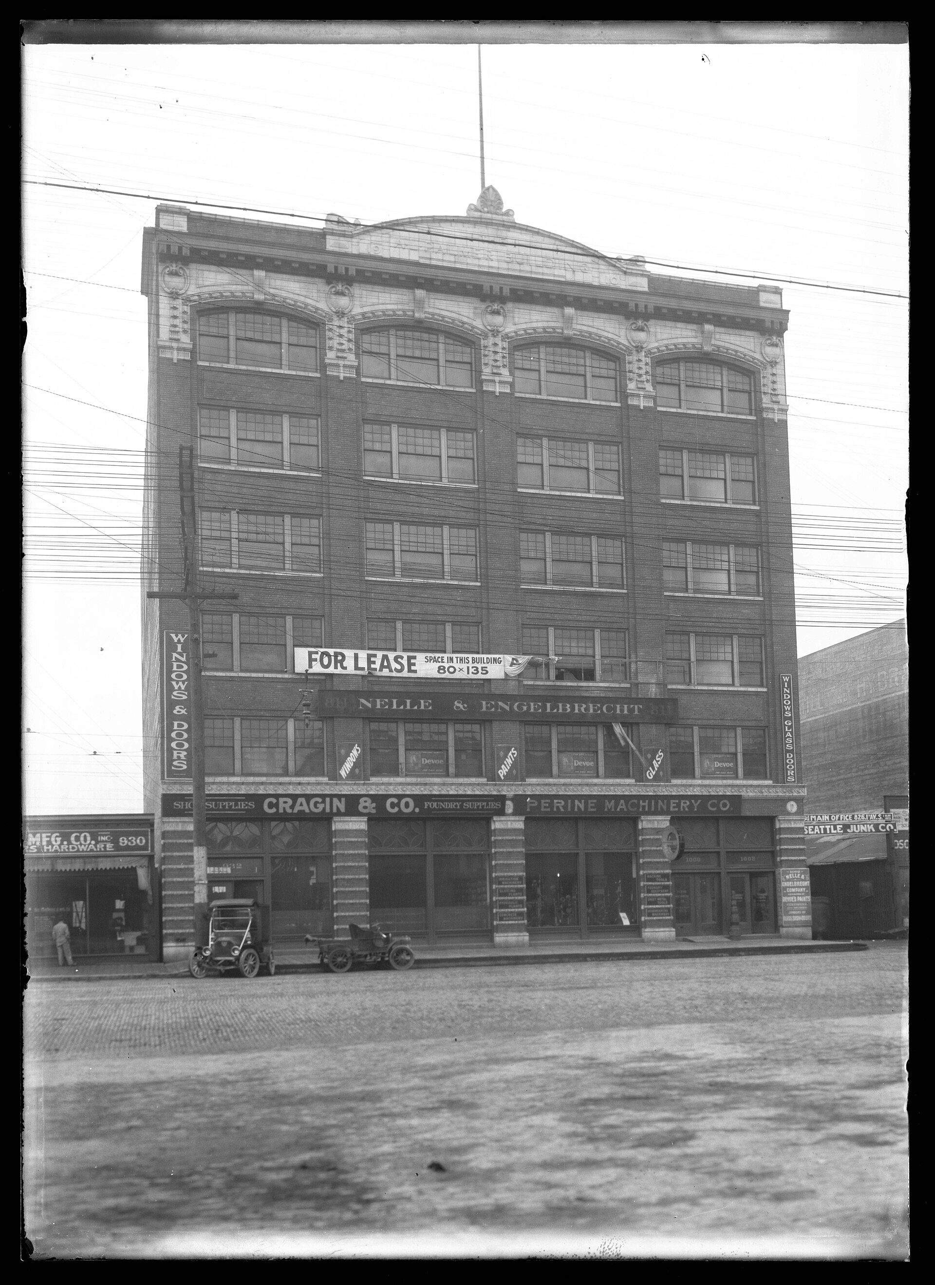 Historical photograph of a row of American storefronts, ca. 1910 — a reminder that small-business tenancy has always lived on rent terms.