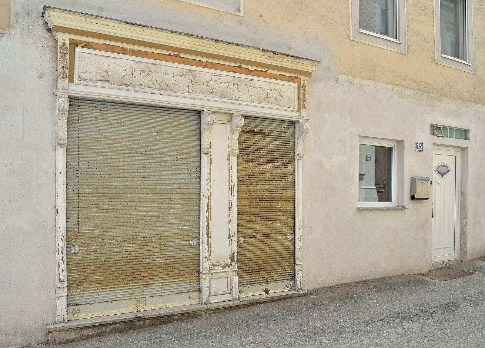 A closed shopfront with its roller shutters pulled down