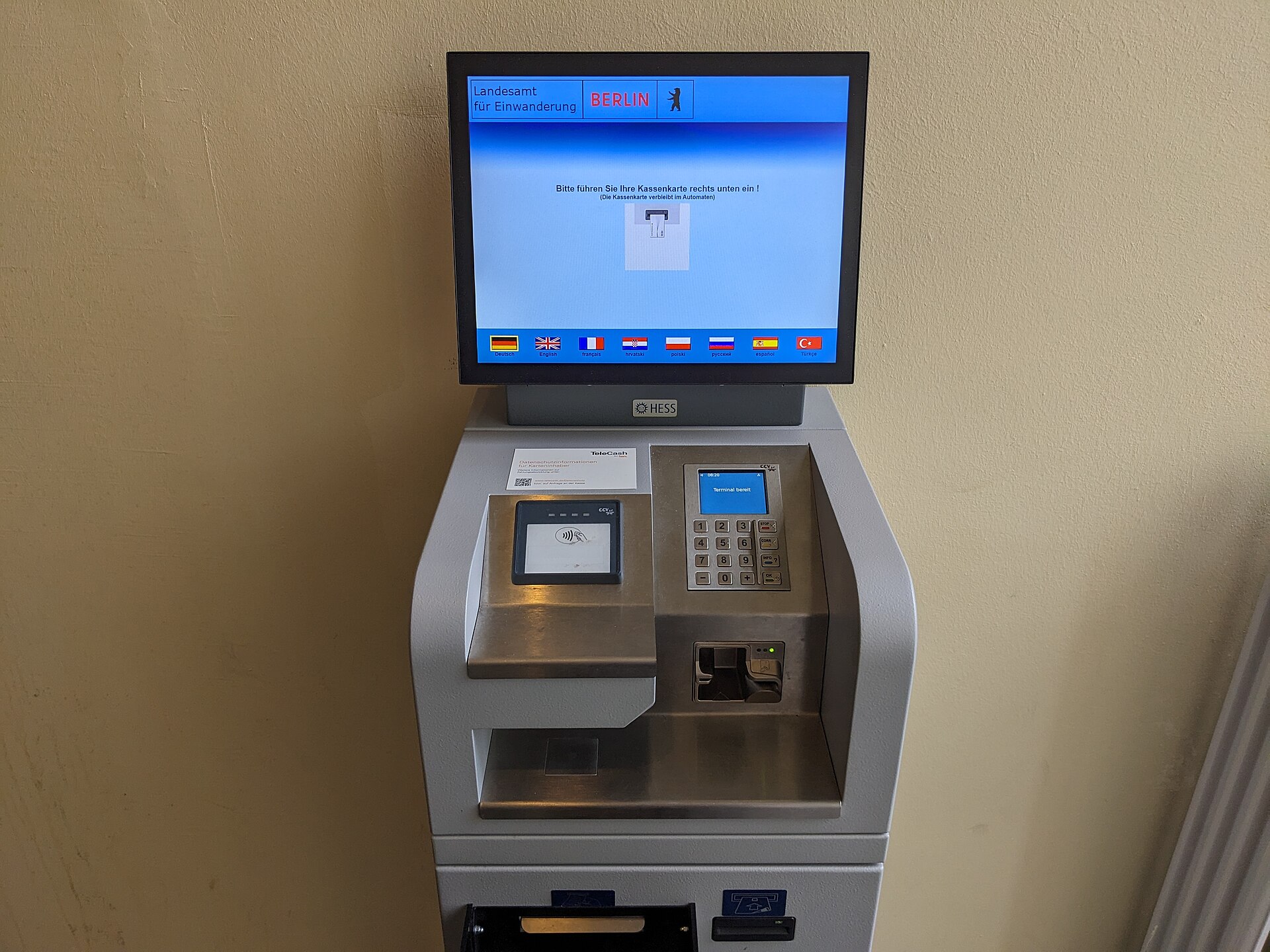 A payment terminal on a counter — the physical link between every sale and the MCA holdback that travels with it.